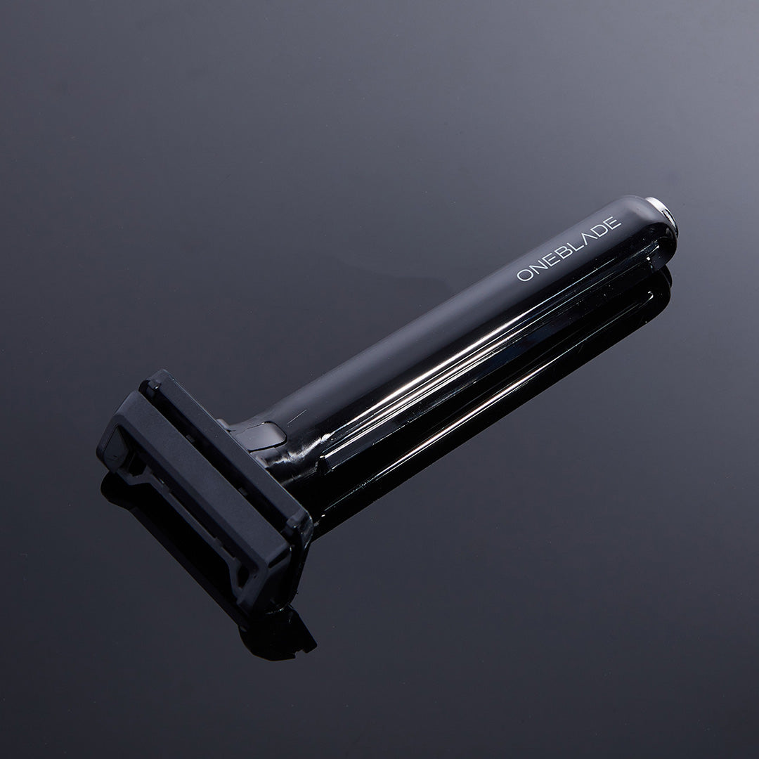 OneBlade Core Single Blade Safety Razor resting on mirrored glass